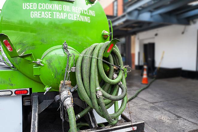 a pump truck emptying a grease trap in East Leroy, MI